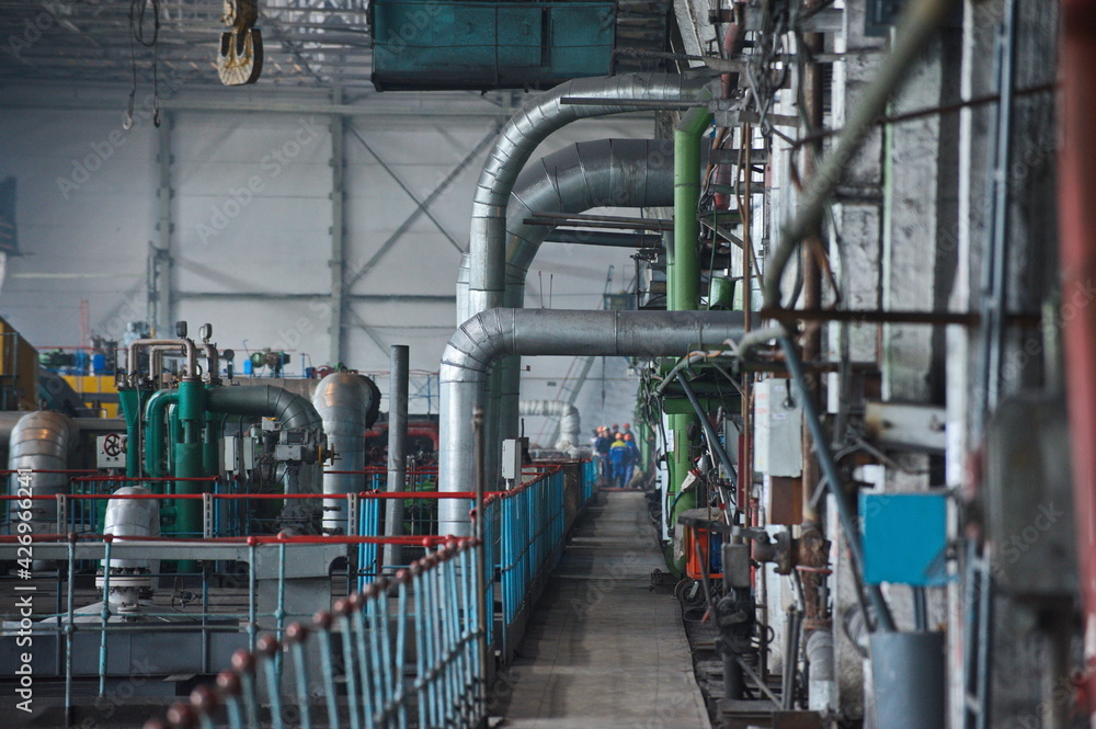 Petropavlovsk, Kazakhstan - 05.26.2015 : The territory of the power plant with large industrial compartments for turbine generators and pipes. Petropavlovsk, Kazakhstan - 05.26.2015 : The territory of the power plant with large industrial compartments for turbine generators and pipes.