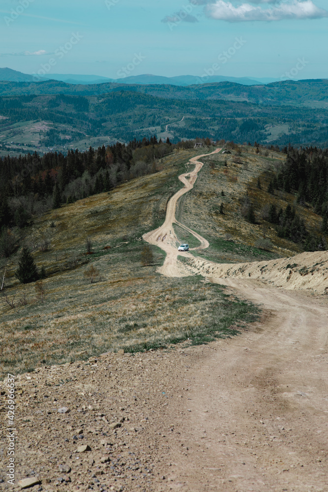 car travel concept suv driving by country road leading to the mountains car travel concept suv driving by country road leading to the mountains