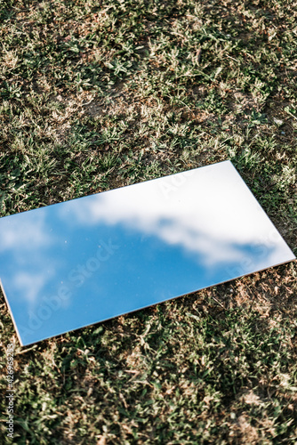 Amazing flat lay of a mirror on the grass