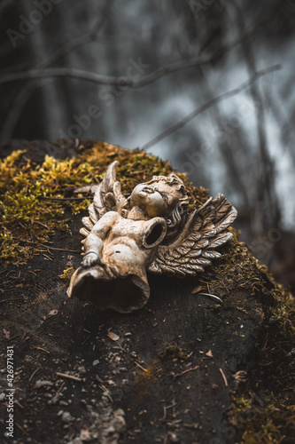 Broken sculpture of an angel in the mountains.