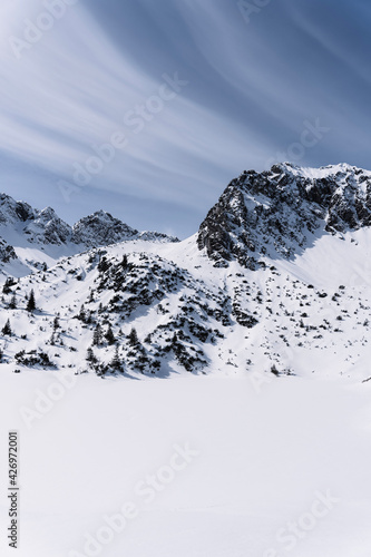 Snowy peak of the Rubihorn mountain in the Alps with breathtaking clouds.
