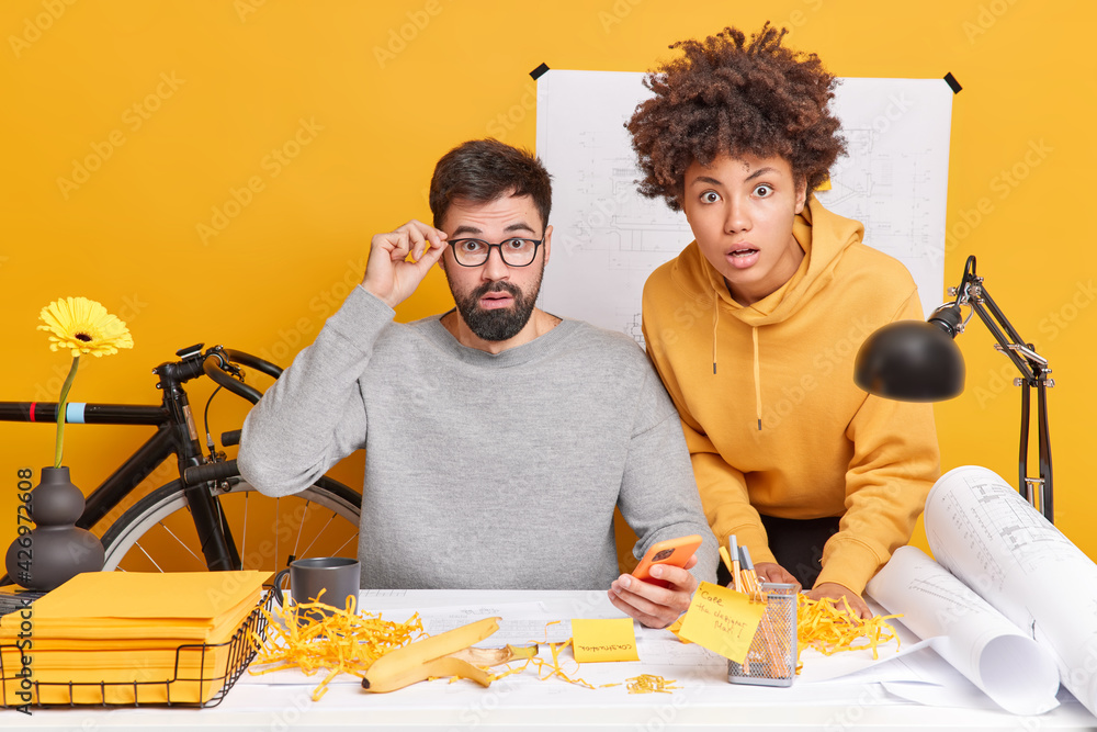 Ταπετσαρία Surprised professional female and male engineers draft together create plans make blueprints for future project stunned to find out big mistake pose at desktop with sketches around