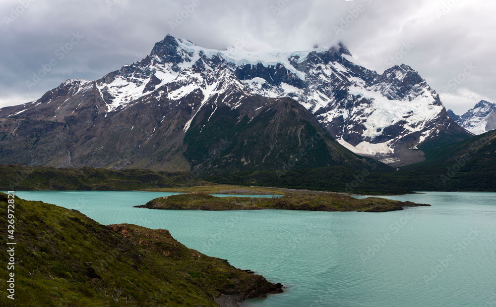 Glacial coloured lake in the mountains of Patagonia with stormy sky with heavy clouds 