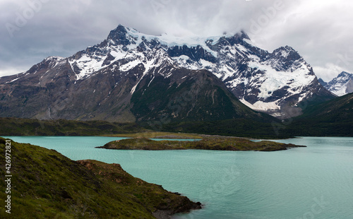Fototapeta Naklejka Na Ścianę i Meble -  Glacial coloured lake in the mountains of Patagonia with stormy sky with heavy clouds 