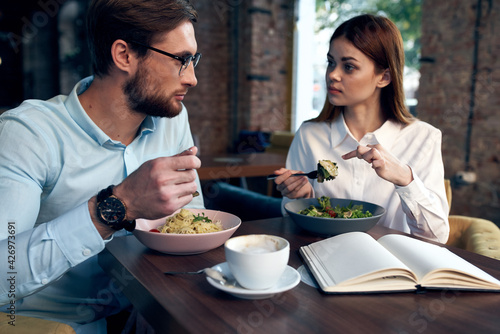 business man and woman sitting in a cafe snack communication lifestyle