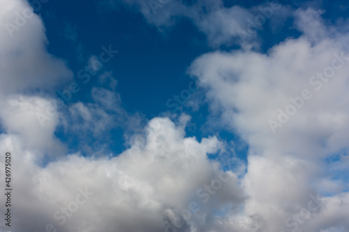 Sky with contrasting cumulus clouds. Heavenly drawing. 