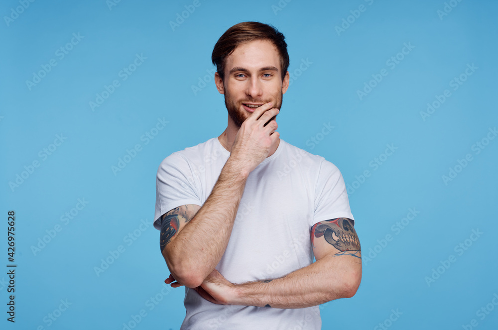 Cheerful man in white t-shirt tattoo on his arms cropped view fashion Cheerful man in white t-shirt tattoo on his arms cropped view fashion