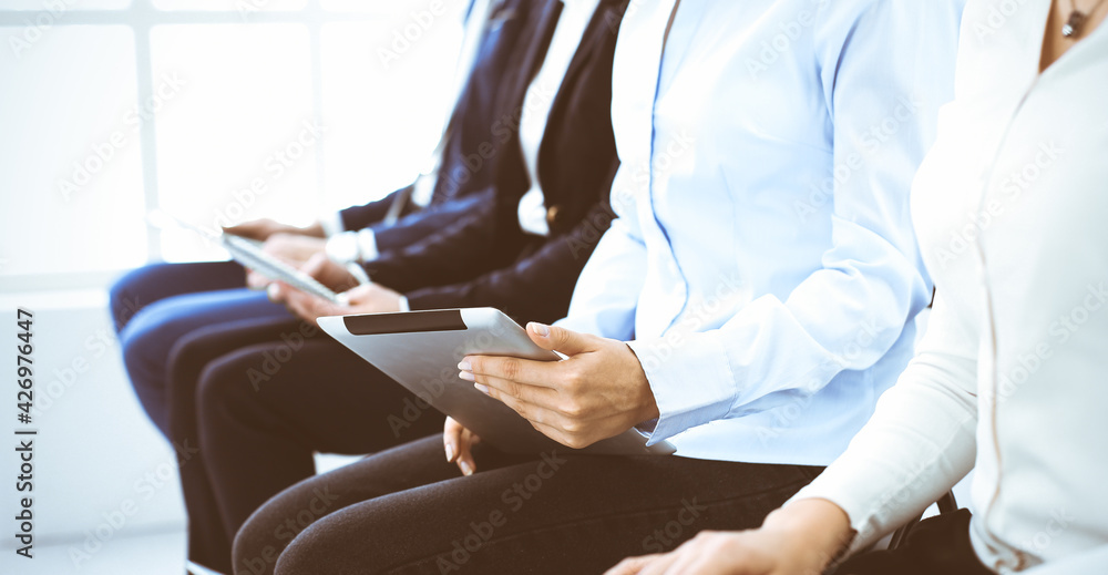 Fototapeta premium Group of business people working in office, close-up. Businesswoman typing on laptop. Conference, training or meeting concepts