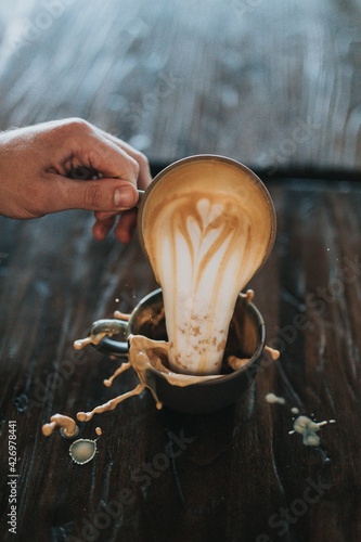 hand holding a bowl of tea