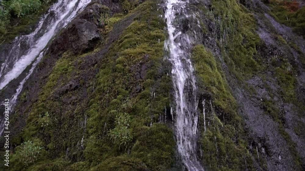 waterfall in the mountains. water flows down the rock waterfall in the mountains. water flows down the rock