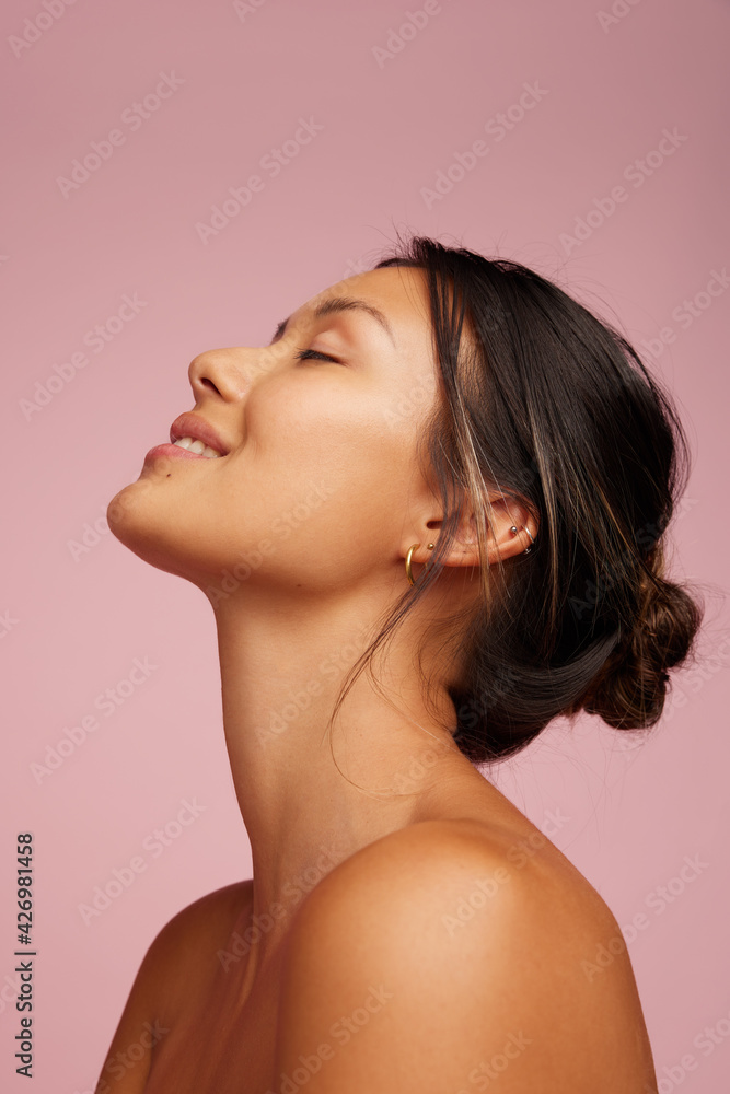 Happy young woman with healthy skin showing skincare. Happy young woman with healthy skin showing skincare.