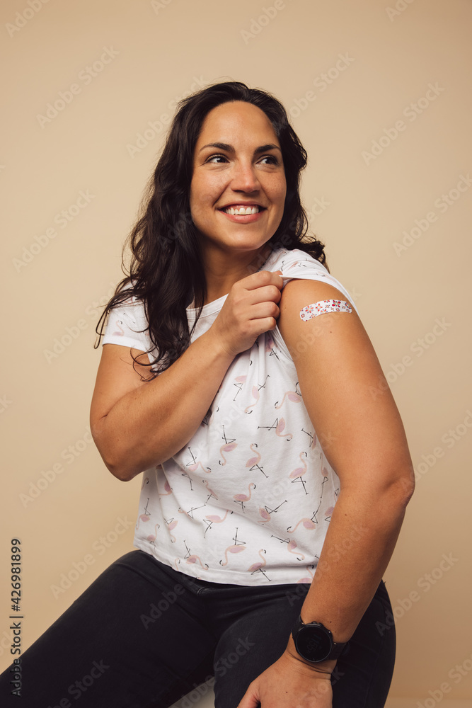Fototapeta premium Proud woman with vaccination
