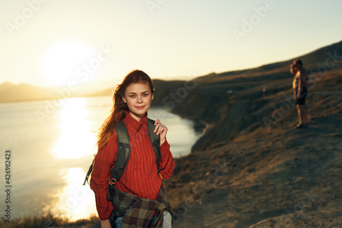 cheerful woman hiker outdoors rocky mountains landscape sun vacation
