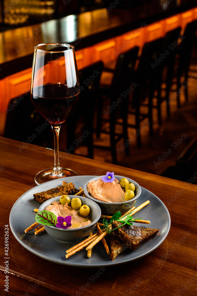 Meat liver pate on toasted bread with fruit seeds on brown table Meat liver pate on toasted bread with fruit seeds on brown table