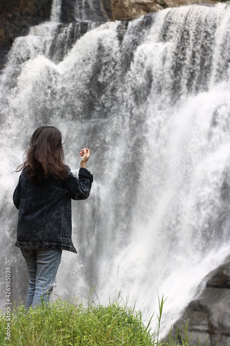 the woman in the middle of the waterfall