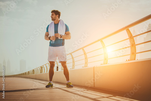 Sportive athletic man running outdoors