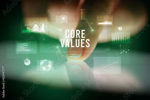 Finger touching tablet with business graphs and icons concept