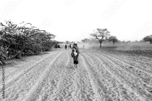 Farmer from Myanmar walking through the desert