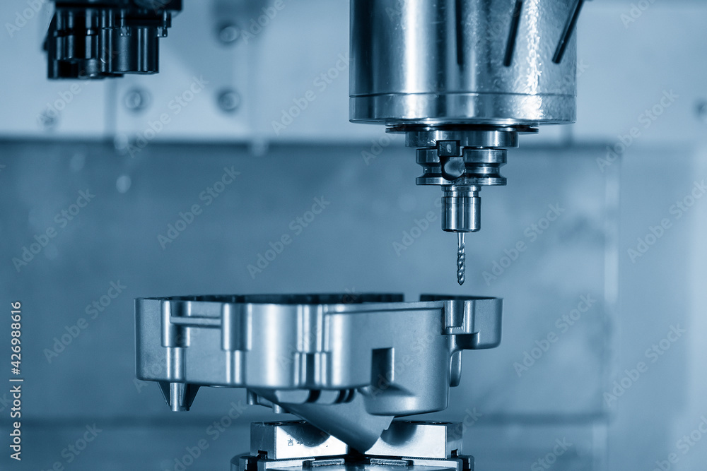 The 4-axis simultaneous machining center tapping the motorcycle gear case parts on the rotary table. The hi-precision automotive manufacturing process by multi-axis CNC milling machine. The 4-axis simultaneous machining center tapping the motorcycle gear case parts on the rotary table. The hi-precision automotive manufacturing process by multi-axis CNC milling machine.