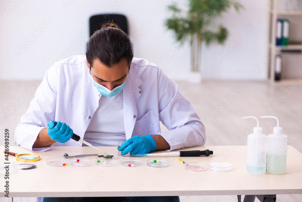 Young male chemist working in the lab during pandemic Young male chemist working in the lab during pandemic