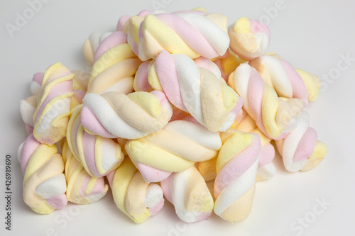 heap of mixed marshmallow candy in yellow, pink, orange and white