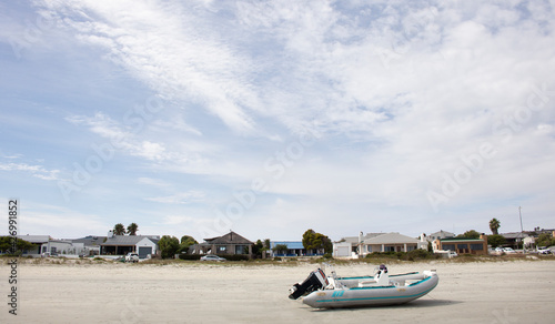 Langebaan Lagoon, South Africa. A Beautiful tourist destination with homes and speed boat with wispy cloud blue sky.