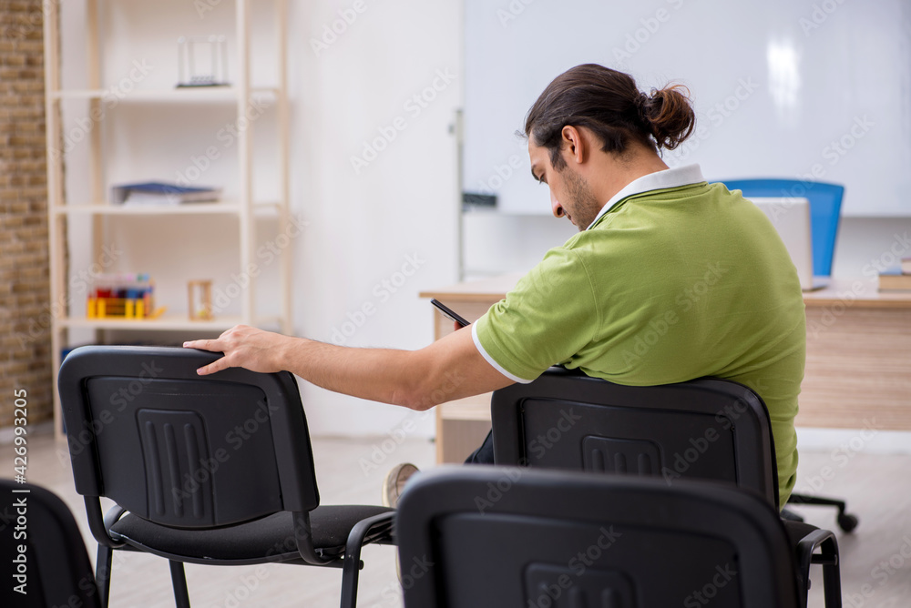 Young male student in business presentation concept Young male student in business presentation concept