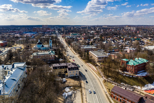 a panoramic view of the golden towers and ancient architectural solutions of the Trinity-Sergius Lavra in Sergiev Posad on a sunny spring day filmed from a drone 