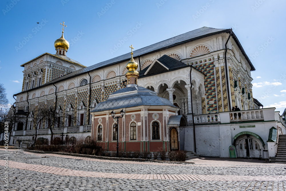 Fototapeta premium golden towers and ancient architectural solutions of the Trinity-Sergievskaya Lavra in Sergiev Posad on a sunny spring day 