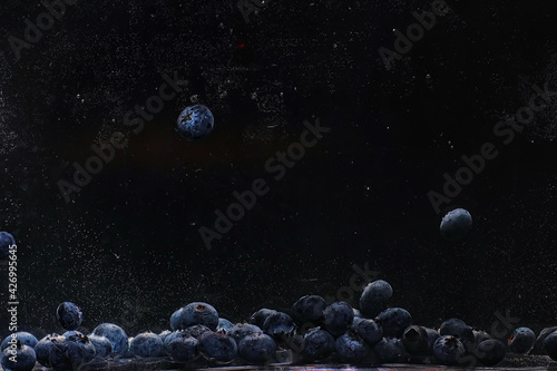Fototapeta Naklejka Na Ścianę i Meble -  Water drops on ripe sweet blueberry. Fresh blueberries background with copy space for your text. Vegan and vegetarian concept.