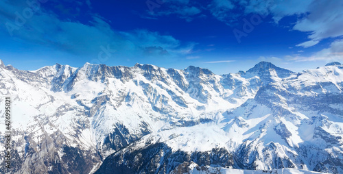 Panoramic of Swiss Mountain against the blue sky bckground
