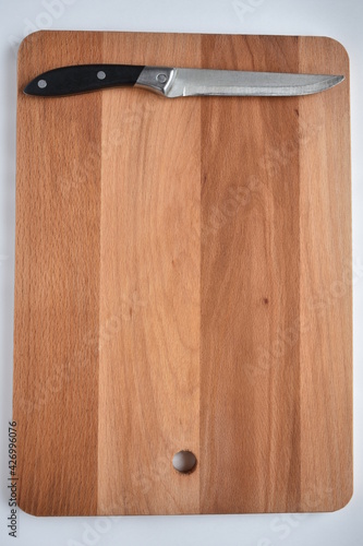 wooden cutting board with a kitchen knife,