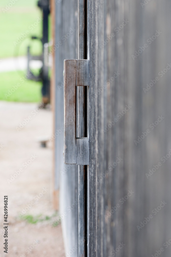 Wooden handle on a barn door vertical Wooden handle on a barn door vertical