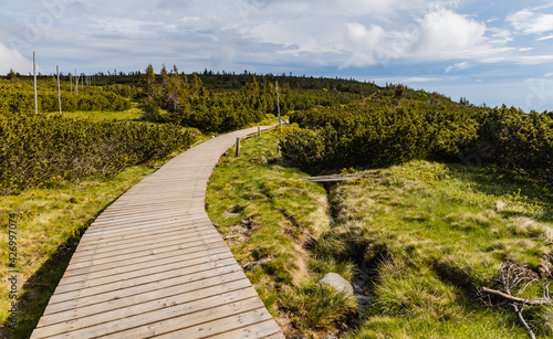 Long mountain trail with panorama of Karkonosze Giant Mountains around photo