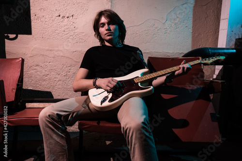 portrait of a musician. Handsome young man with musical instruments.