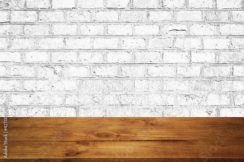 The background is blank wooden boards and a textured brick wall with lighting and vignetting.