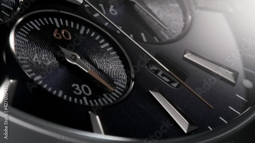 Silver and red second arrow running on the dark blue clockface of luxury swiss watch with chronograph and metallic details. Closeup with zoom-in effect 