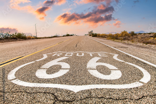 Route 66 road sign with blue sky background. Classic concept for travel and adventure in a vintage way.