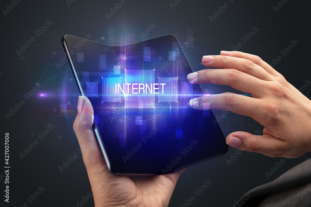 Businessman holding a foldable smartphone Businessman holding a foldable smartphone