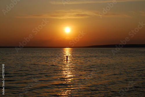 Swimming at sunset © lanoo