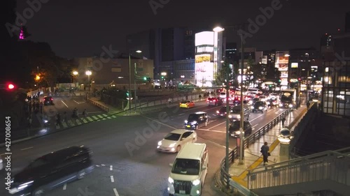 shibuya, japan - november 02 2020: Video of a lighted up advertising truck crossing at the intersection of Gorinbashi bridge leading to Harajuku at night. photo