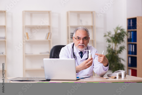Experienced male doctor working in the clinic