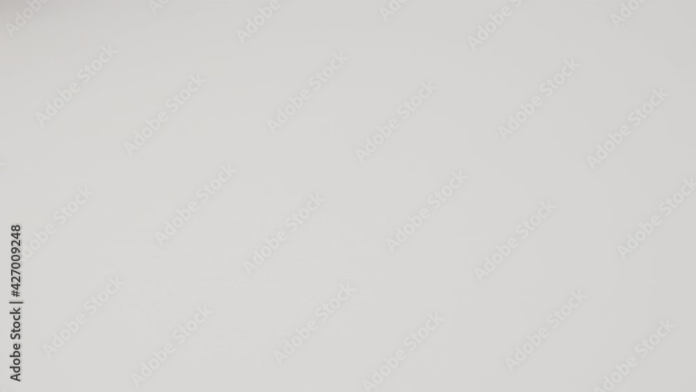 Chicken egg rotates on a white background. Close-up of an egg. Egg are rolling on the white table. Easter eggs background. Chicken egg rotates on a white background. Close-up of an egg. Egg are rolling on the white table. Easter eggs background.