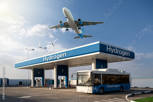 Fuel cell bus at the hydrogen filling station and airplane in the sky. Clean mobility concept