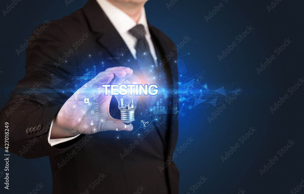 Fototapeta premium Businessman holding a light bulb