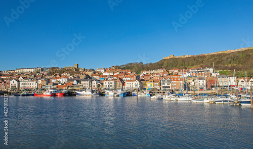 Harbor seafront town with castle on hill