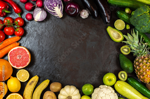 fresh tasty vegetables and fruits on a black background. space for text 