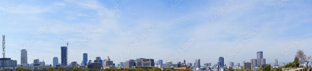 City landscape of Osaka, Japan from Osaka castle park.  Panoramic view during spring. - 大阪の都市景観 大阪城公園から