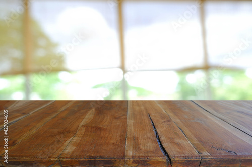 Empty wooden table in front of abstract blurred Cafe, restaurant at night. For montage product display or design key visual layout - Image