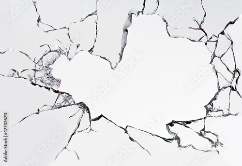 Cracked broken glass on a white background. Damaged window texture